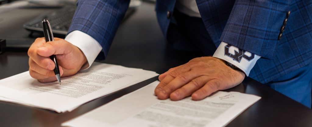 Careers 2 Quiet Professionals person signing a document
