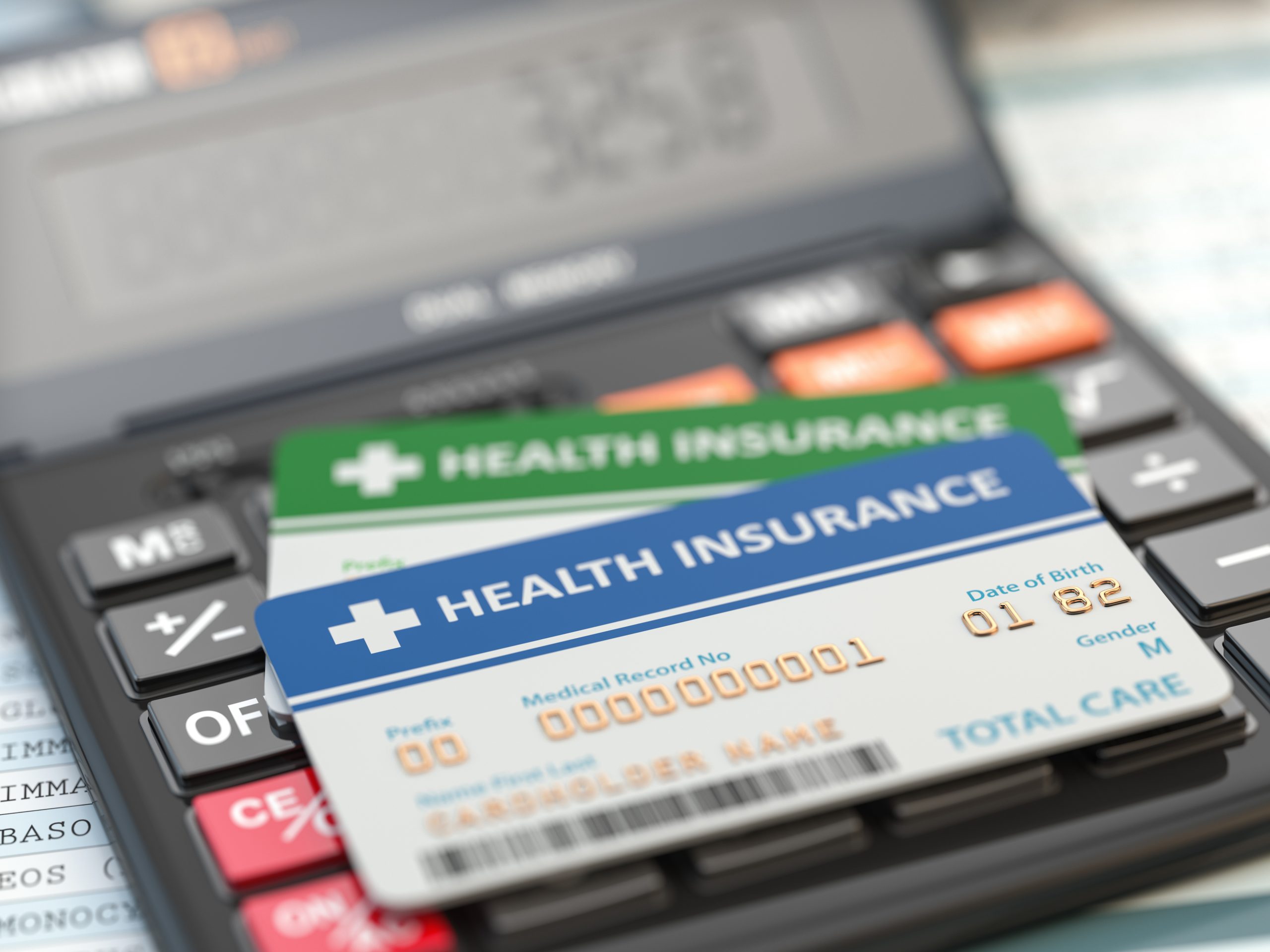 Medical insurance cards on the calculator. Health care costs concept. 3d illustration
