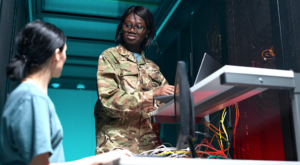 Female Network Engineers Using Laptop in Server Room